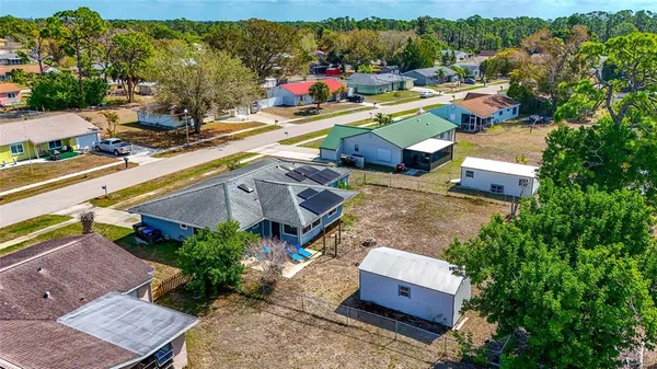 an aerial view of residential houses with outdoor space and swimming pool