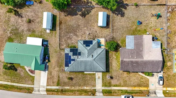 front view of a brick house with a small yard