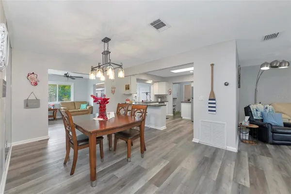 a view of a dining room with furniture and wooden floor