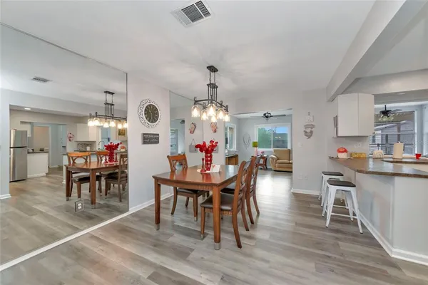 a view of a dining room with furniture and chandelier