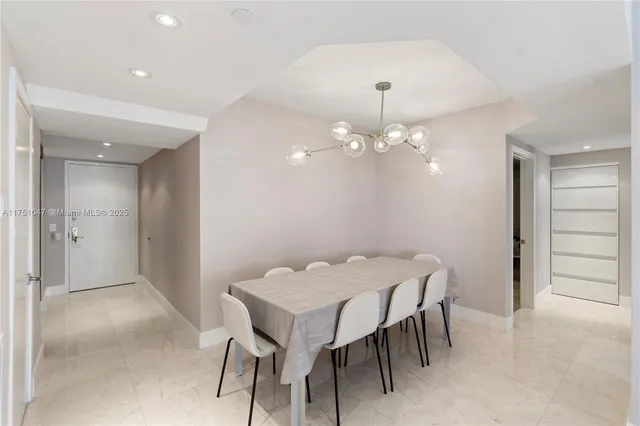 a view of a dining room with furniture and chandelier fan