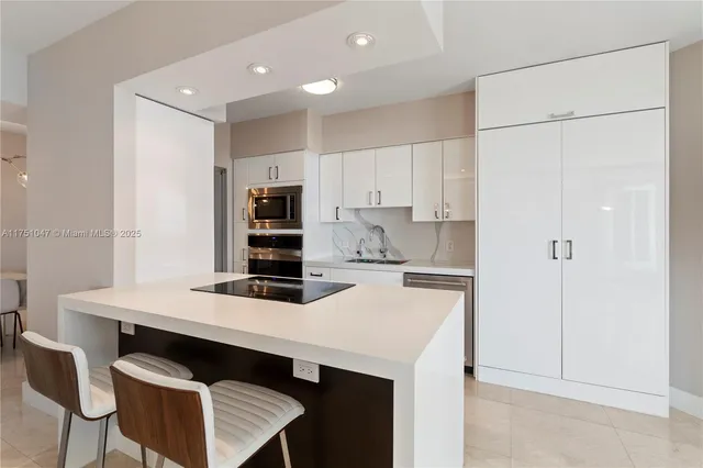 a kitchen with stainless steel appliances granite countertop a refrigerator and a stove