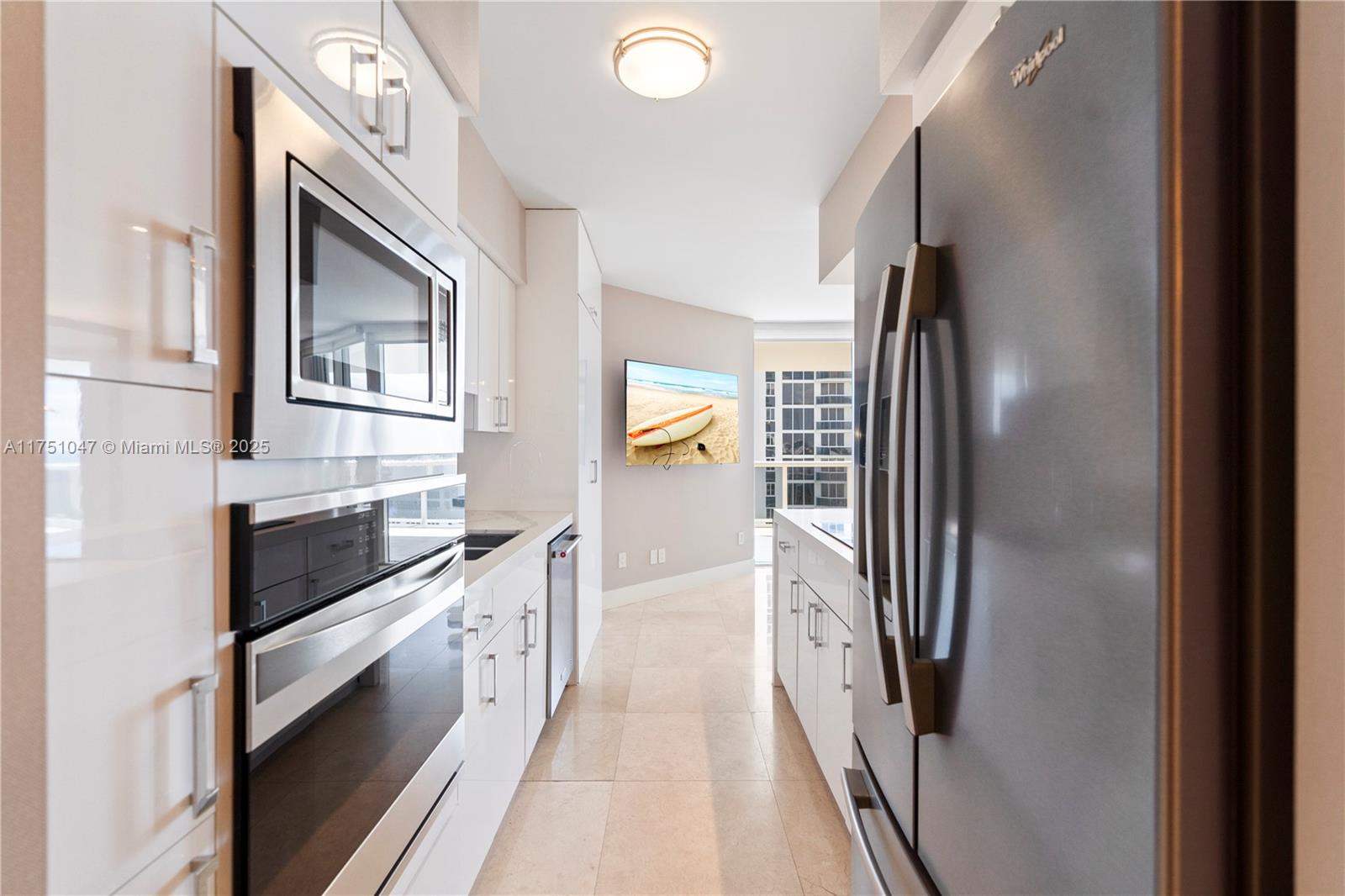 4779 Collins Avenue, Unit 2204 Miami Beach, FL 33140 - Photo 17 of 58 a kitchen with stainless steel appliances granite countertop a refrigerator and a stove