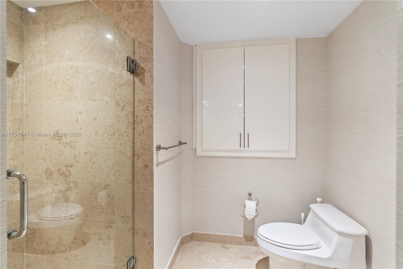 4779 Collins Avenue, Unit 2204 Miami Beach, FL 33140 - Photo 27 of 58 a bathroom with a toilet and a shower
