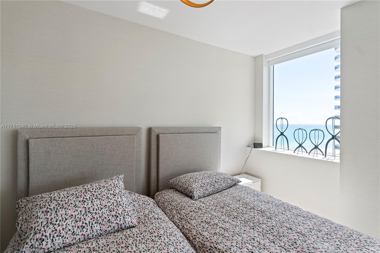 4779 Collins Avenue, Unit 2204 Miami Beach, FL 33140 - Photo 30 of 58 a bedroom with a bed and a window with painted walls