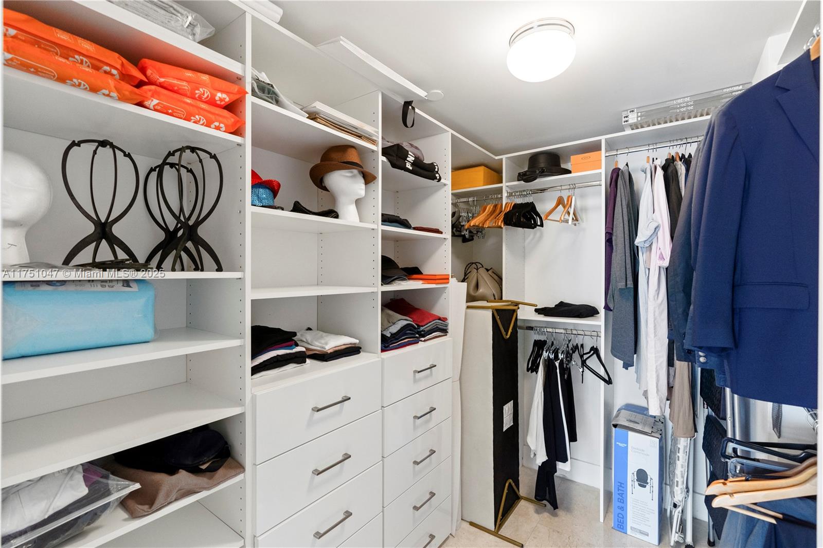 4779 Collins Avenue, Unit 2204 Miami Beach, FL 33140 - Photo 33 of 58 a view of walk in closet with clothes and shoes