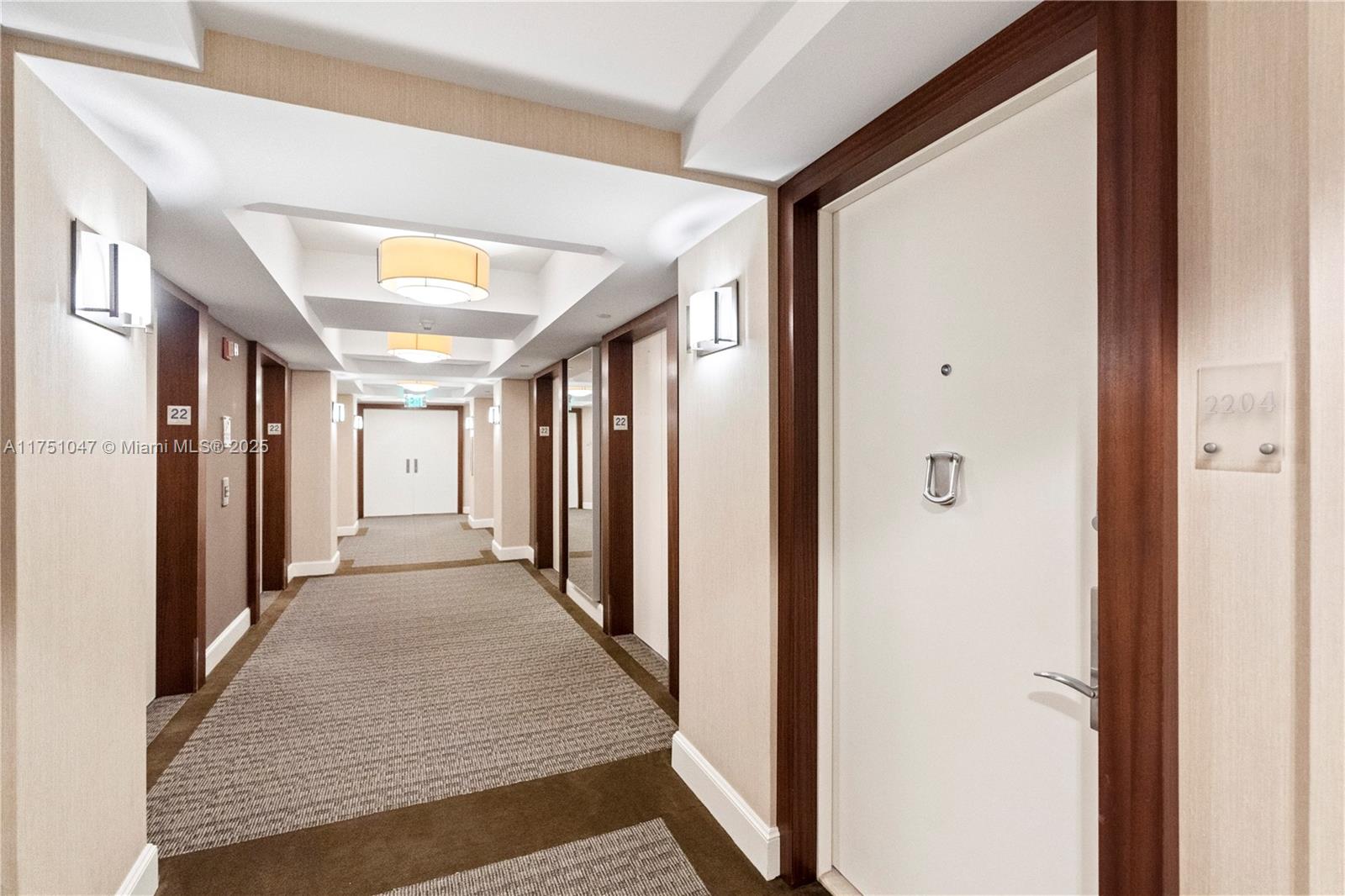 4779 Collins Avenue, Unit 2204 Miami Beach, FL 33140 - Photo 37 of 58 a view of a hallway with wooden floor and staircase