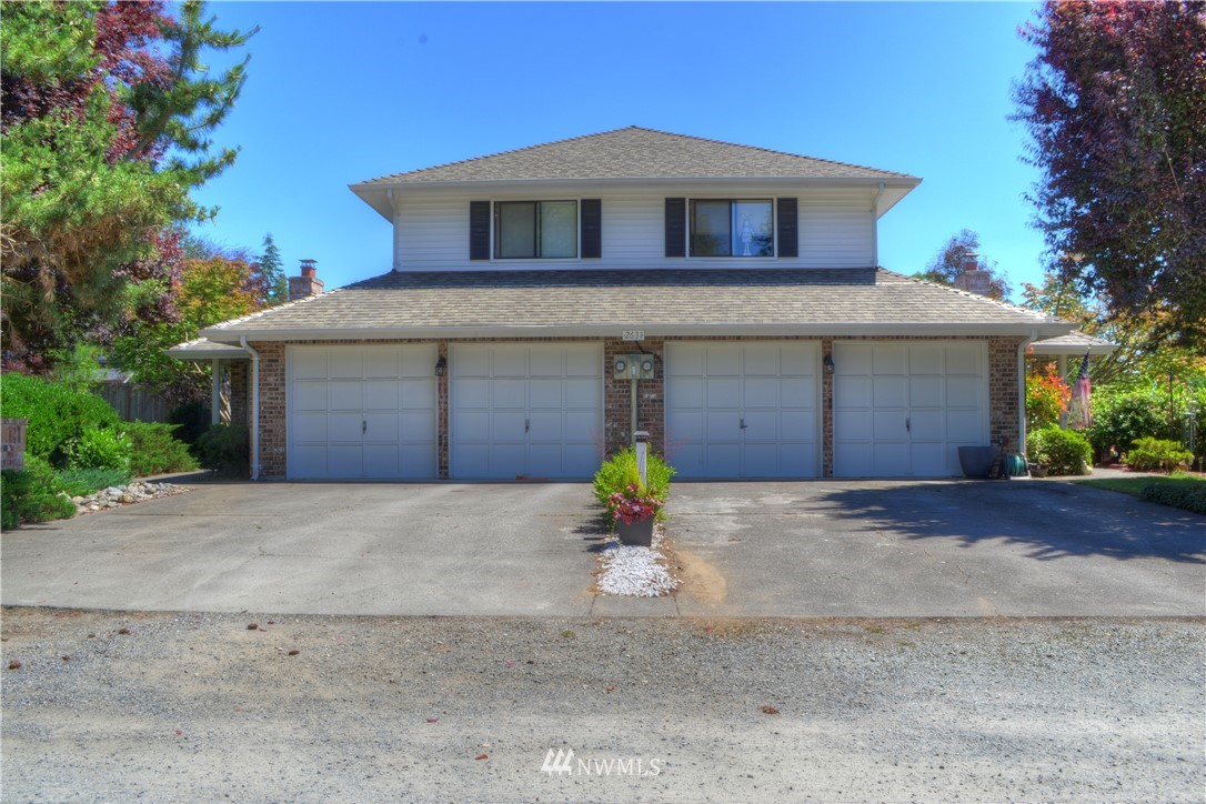 2631 180th Street Southeast, Unit 1&2 Bothell, WA 98012 - Photo 1 of 3 a front view of a house with a yard and garage