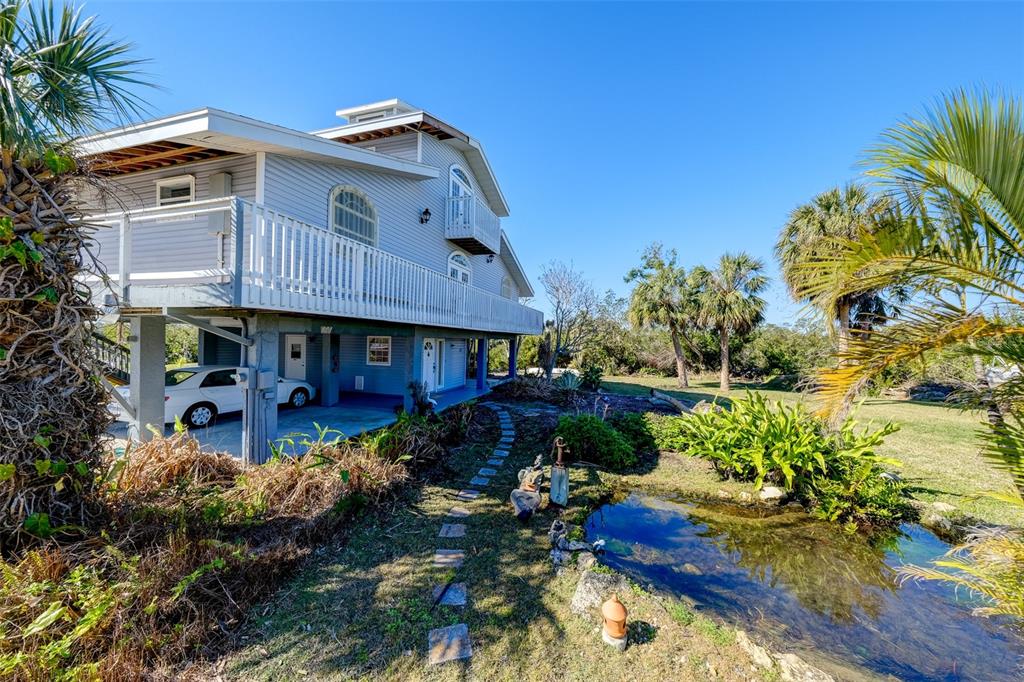 145 Burns Road Terra Ceia, FL 34250 - Photo 19 of 65 a front view of a house with a yard