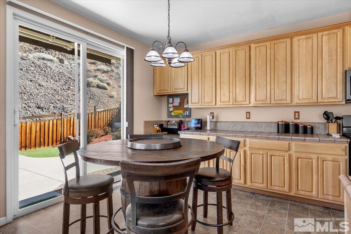 5670 Falcon Ridge Court Sparks, NV 89436 - Photo 11 of 40 a kitchen with a table and chairs