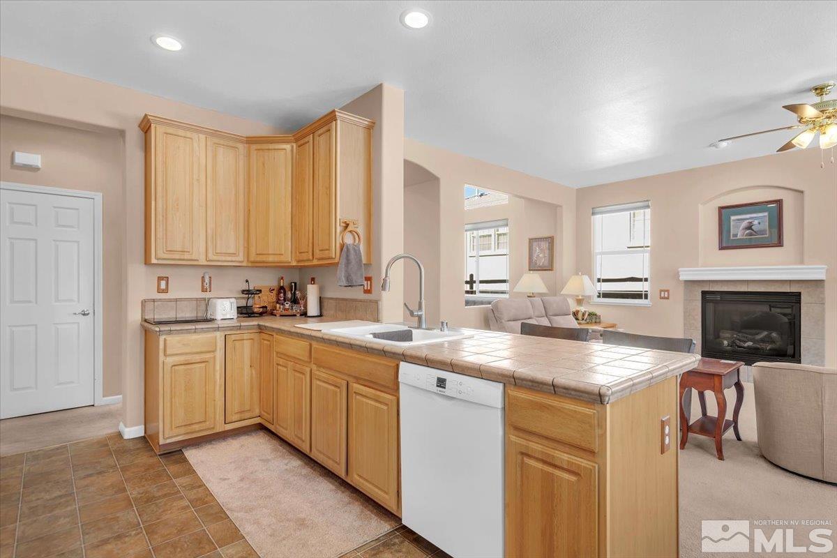5670 Falcon Ridge Court Sparks, NV 89436 - Photo 16 of 40 a kitchen with stainless steel appliances granite countertop a sink and cabinets