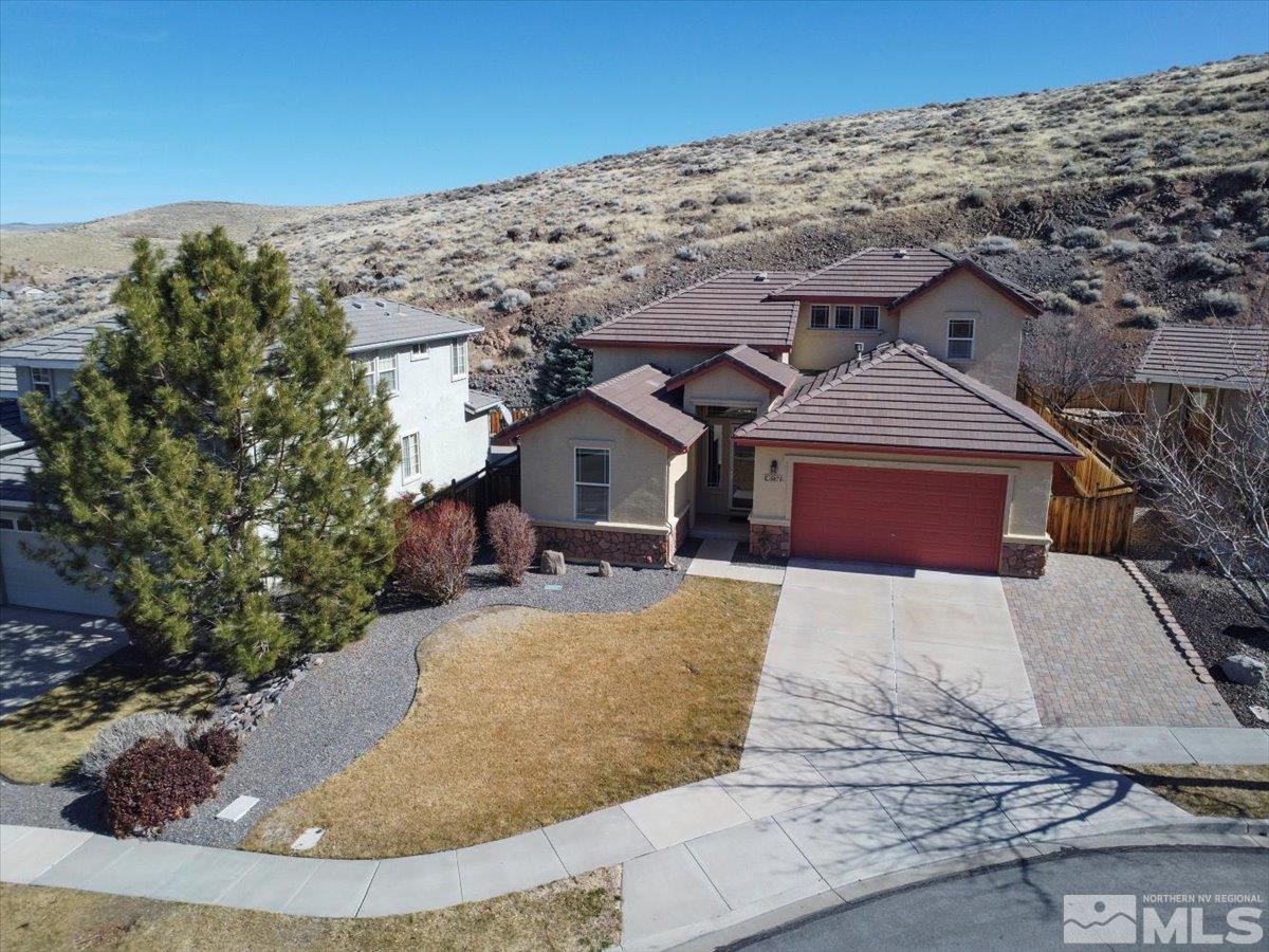 5670 Falcon Ridge Court Sparks, NV 89436 - Photo 2 of 40 a front view of a house with a yard