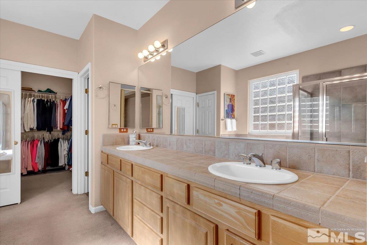 5670 Falcon Ridge Court Sparks, NV 89436 - Photo 21 of 40 a bathroom with a sink double vanity
