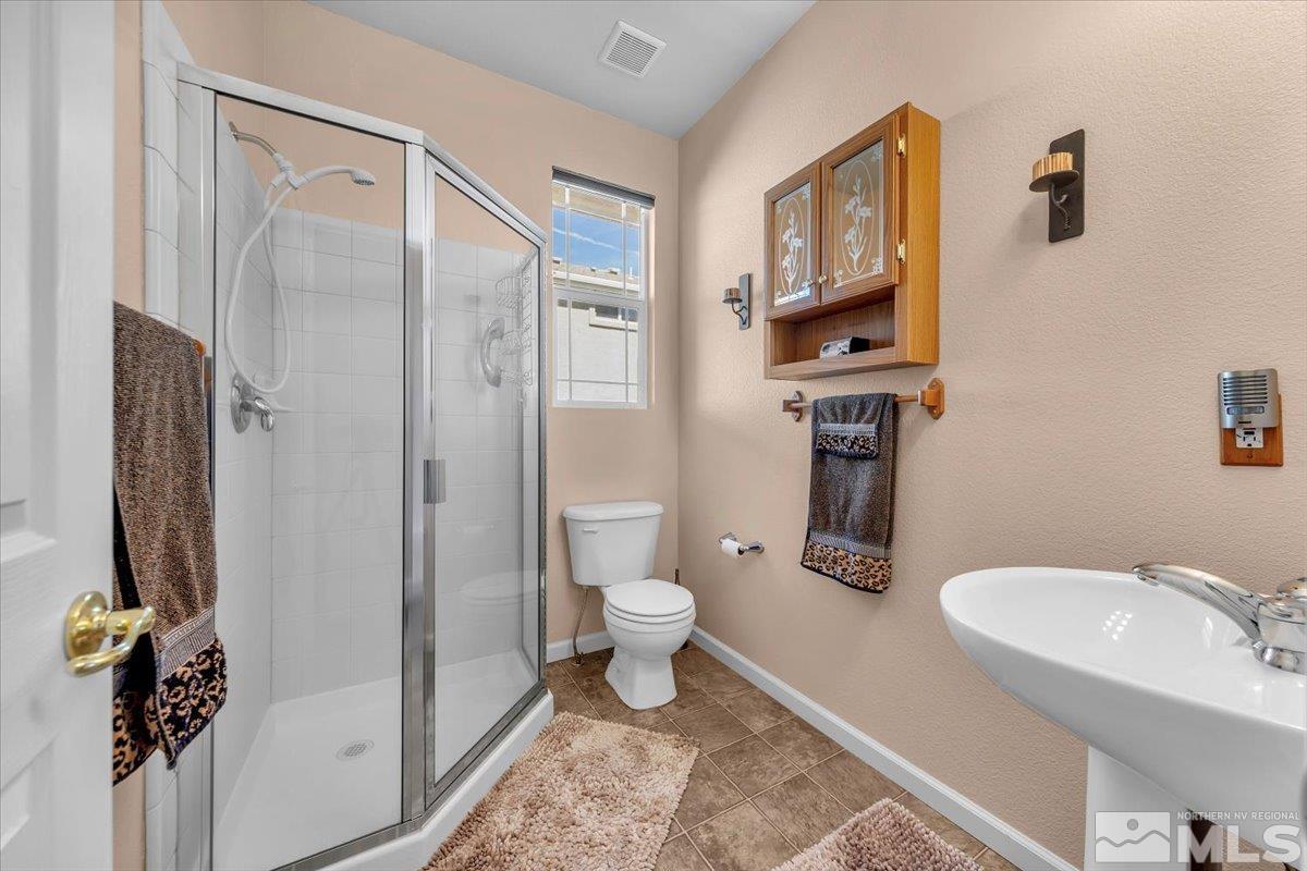5670 Falcon Ridge Court Sparks, NV 89436 - Photo 26 of 40 a bathroom with a granite countertop sink toilet and shower