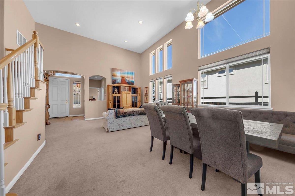 5670 Falcon Ridge Court Sparks, NV 89436 - Photo 3 of 40 a living room with furniture and a dining table with kitchen view
