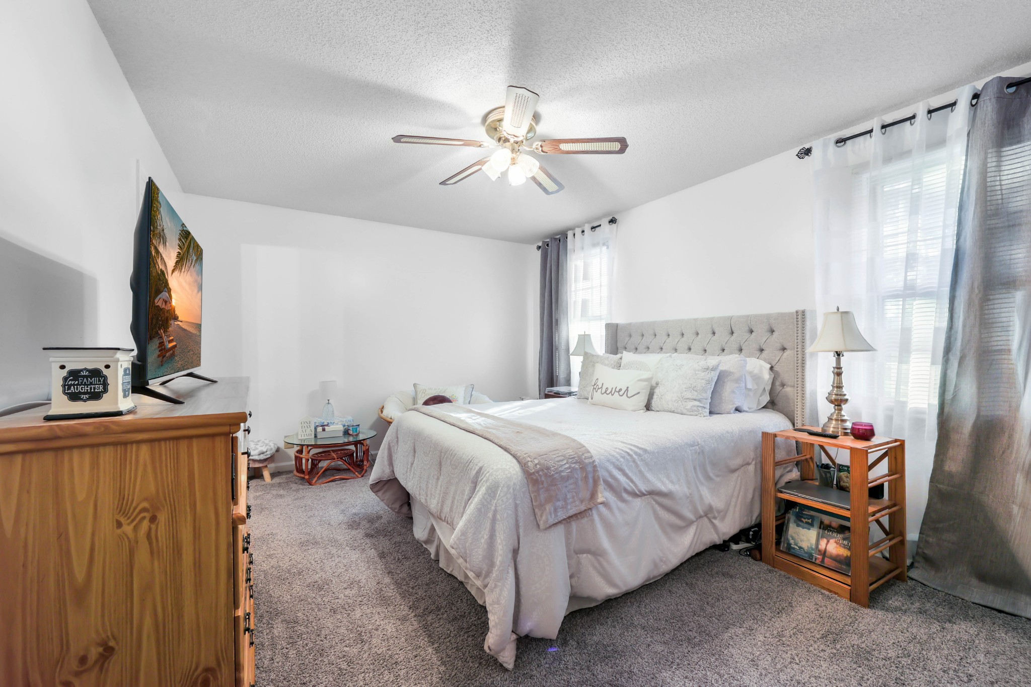 3702 Trenton Road Clarksville, TN 37042 - Photo 20 of 26 a bedroom with a bed and a flat tv screen on dresser