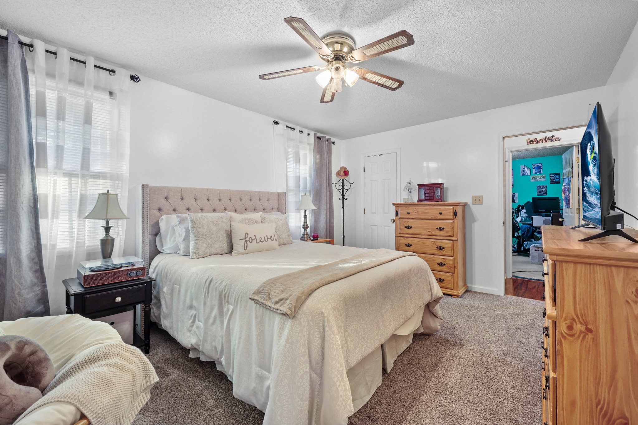 3702 Trenton Road Clarksville, TN 37042 - Photo 21 of 26 a bedroom with a bed dresser and a chandelier