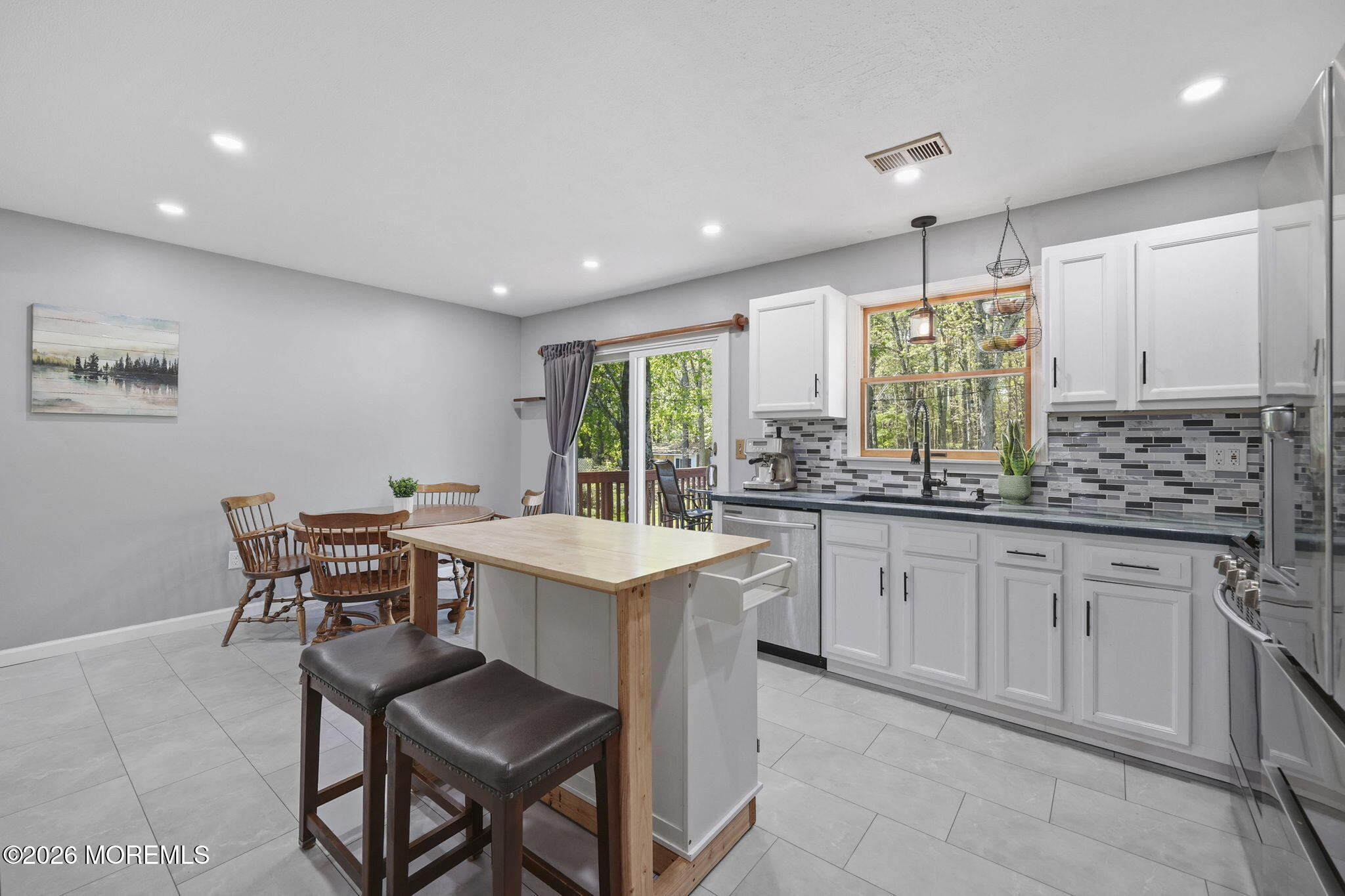 356 Leesville Road Jackson, NJ 08527 - Photo 20 of 46 a kitchen with a table chairs sink and cabinets