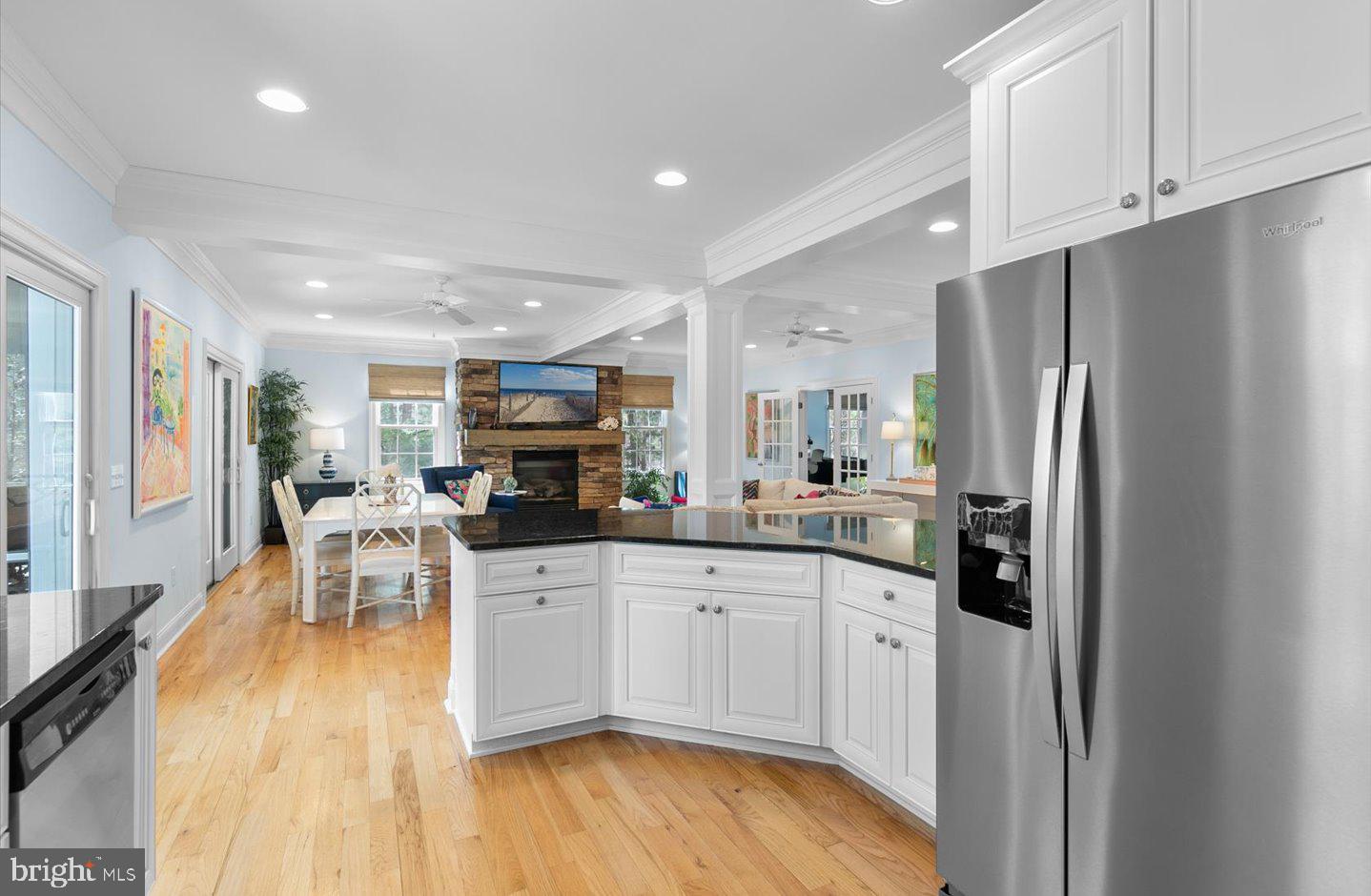 21 Cedar Road Rehoboth Beach, DE 19971 - Photo 16 of 59 a kitchen with stainless steel appliances granite countertop a refrigerator a sink a stove and white cabinets with wooden floor