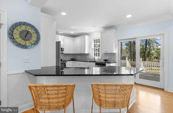 a kitchen with stainless steel appliances granite countertop a sink a stove a microwave a counter top and cabinets