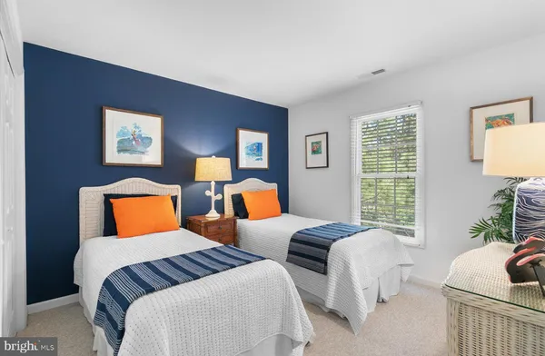 a bedroom with a bed and a potted plant