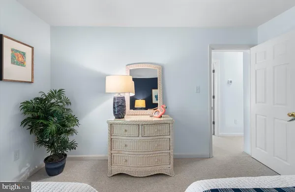 a bedroom with a bed and a potted plant