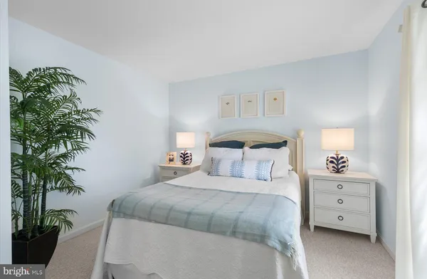 a bedroom with a bed a dresser and mirror