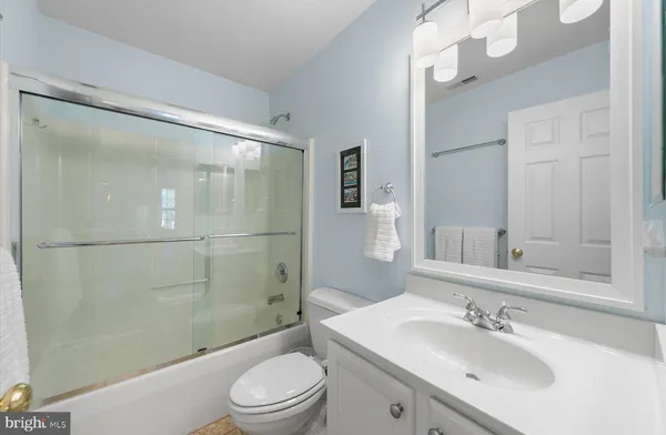 a bedroom with a bed and a lamp