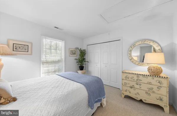 a bedroom with a bed and a lamp