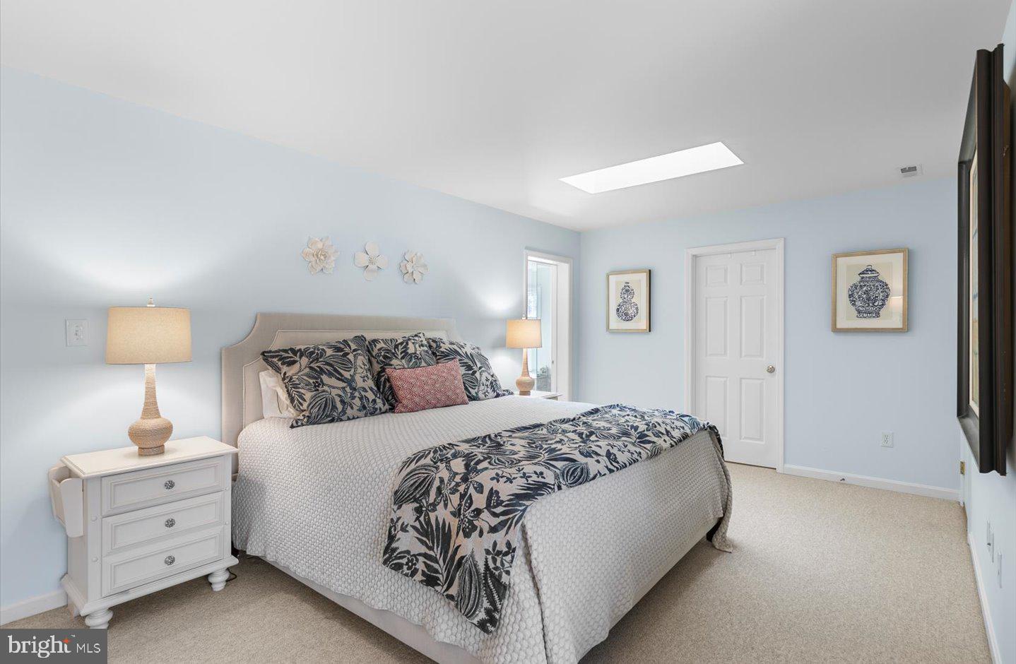 21 Cedar Road Rehoboth Beach, DE 19971 - Photo 39 of 59 a bedroom with a bed and a lamp