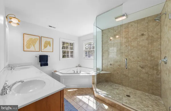 a bedroom with a bed a mirror on dresser and a table