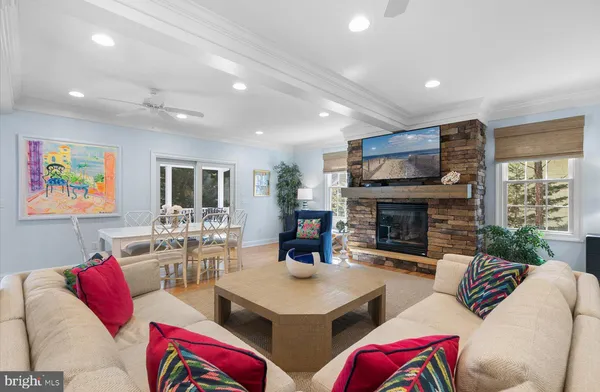 a living room with furniture fireplace and flat screen tv