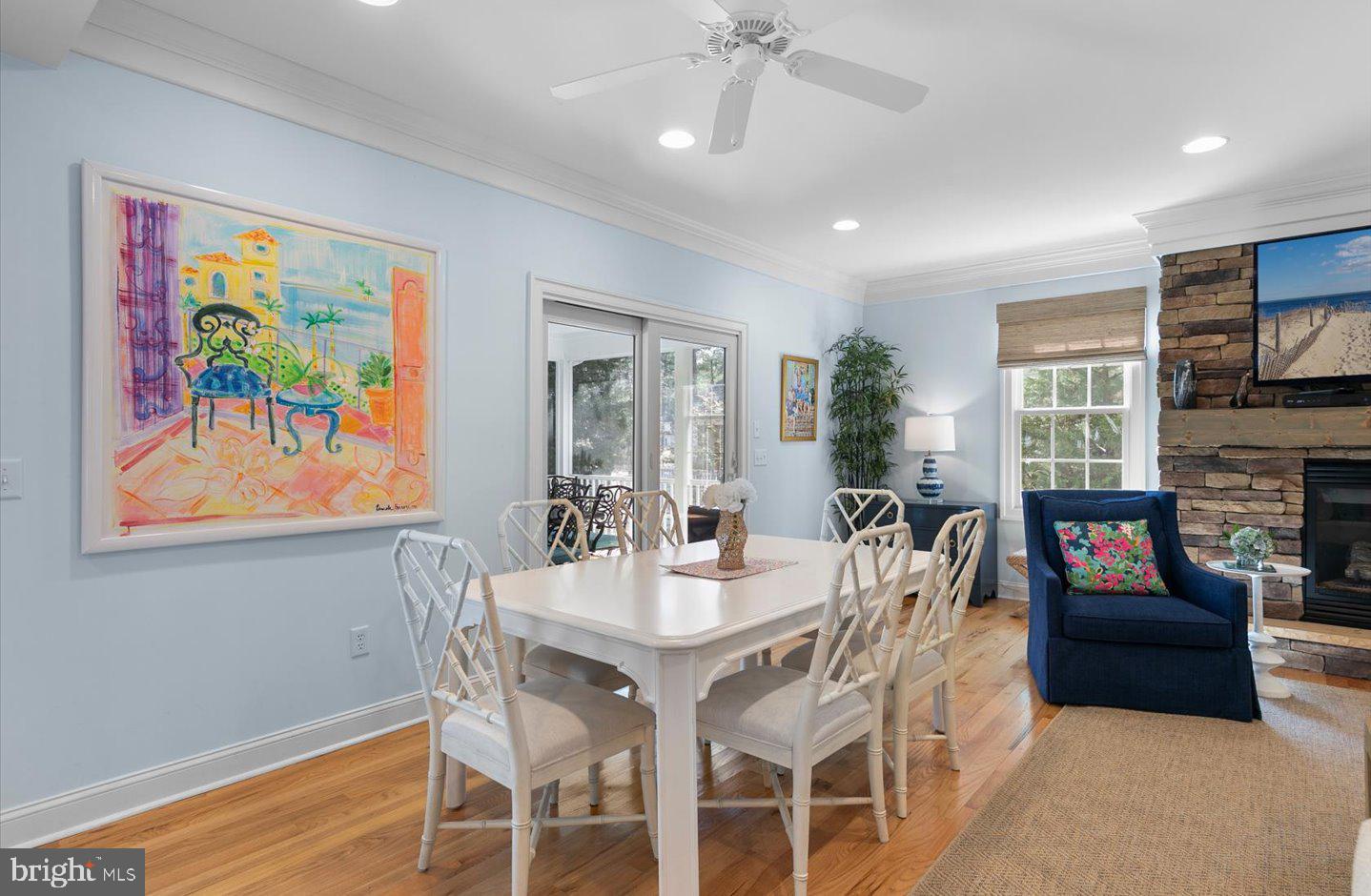 21 Cedar Road Rehoboth Beach, DE 19971 - Photo 10 of 59 a view of a dining room with furniture a fireplace and wooden floor