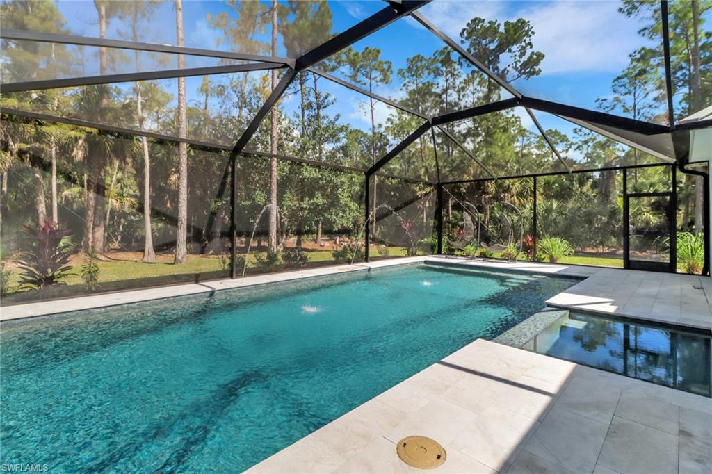 421 35th Avenue Northeast Naples, FL 34120 - Photo 15 of 39 a view of swimming pool with a yard