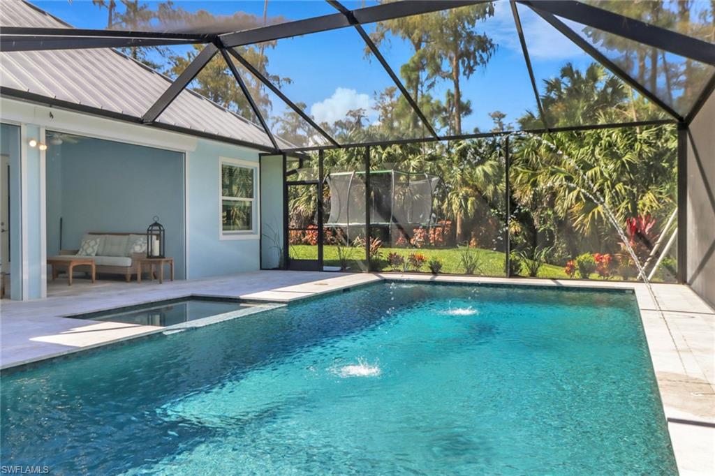 421 35th Avenue Northeast Naples, FL 34120 - Photo 17 of 39 a view of swimming pool with a patio and a yard