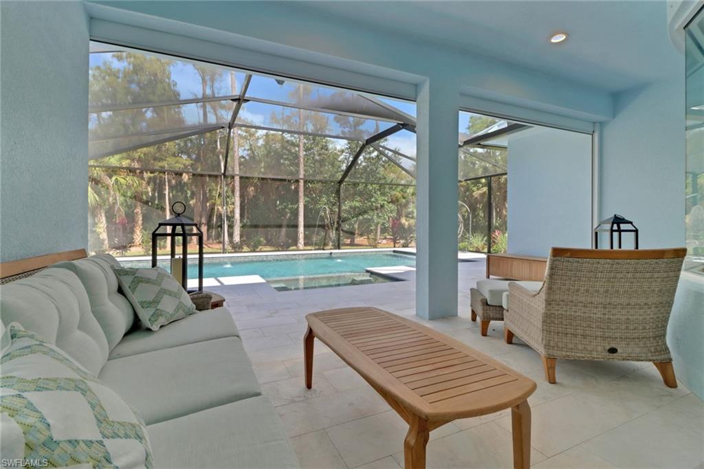 421 35th Avenue Northeast Naples, FL 34120 - Photo 18 of 39 a living room with furniture and a floor to ceiling window