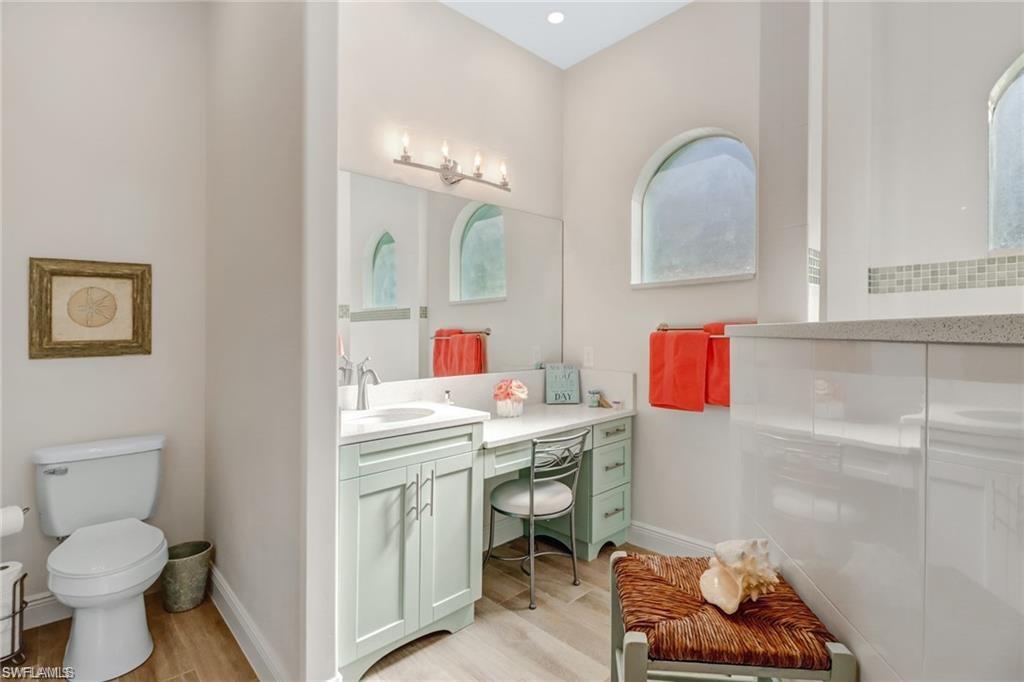 421 35th Avenue Northeast Naples, FL 34120 - Photo 22 of 39 a bathroom with a sink toilet vanity and tub