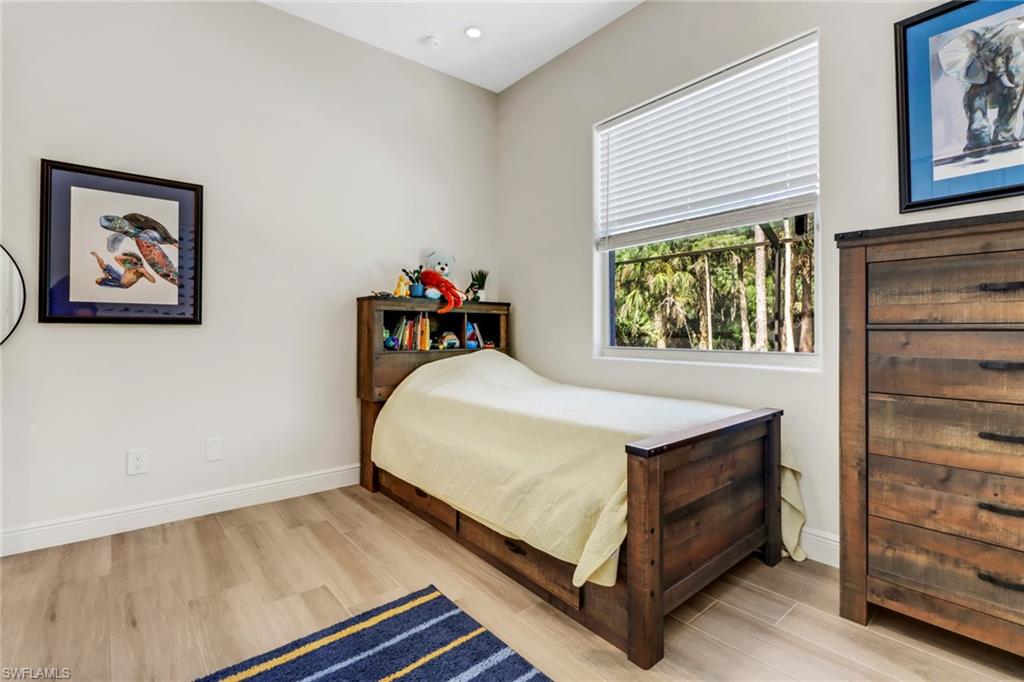 421 35th Avenue Northeast Naples, FL 34120 - Photo 23 of 39 a bedroom with a bed and a window