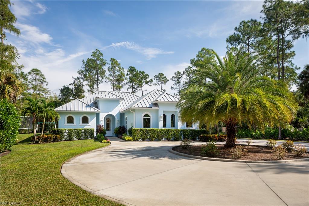 421 35th Avenue Northeast Naples, FL 34120 - Photo 29 of 39 a front view of a house with a yard