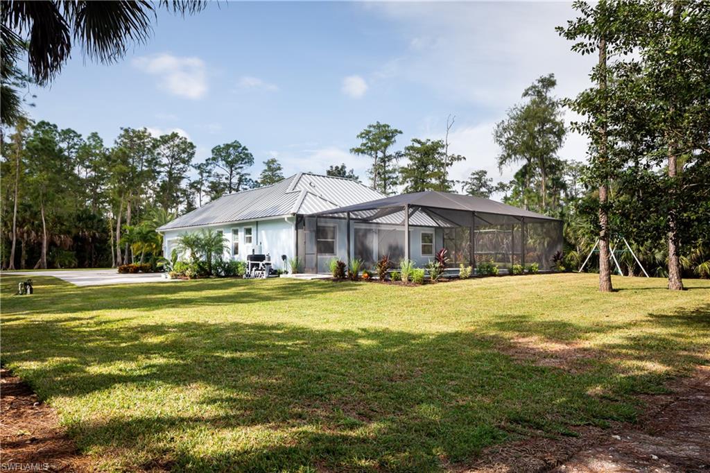 421 35th Avenue Northeast Naples, FL 34120 - Photo 31 of 39 a front view of house with yard and swimming pool