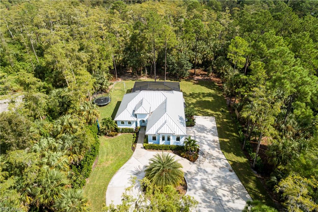 421 35th Avenue Northeast Naples, FL 34120 - Photo 34 of 39 a view of a house with a yard