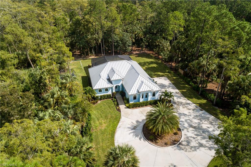 421 35th Avenue Northeast Naples, FL 34120 - Photo 36 of 39 a view of a house with a yard