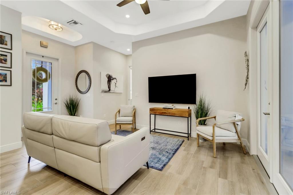 421 35th Avenue Northeast Naples, FL 34120 - Photo 6 of 39 a living room with furniture and a flat screen tv