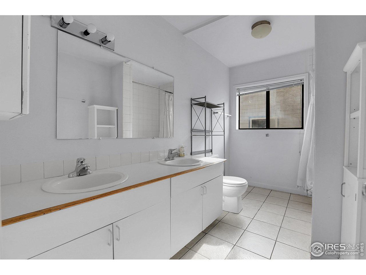 1628 4th Street Boulder, CO 80302 - Photo 17 of 27 a bathroom with a toilet sink and mirror