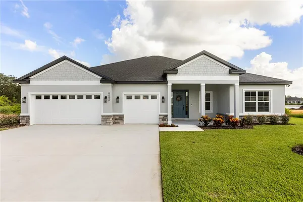 a view of a house with patio and a yard