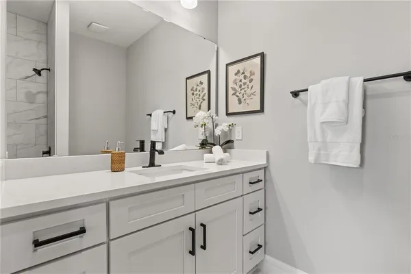 a bathroom with a sink and a mirror