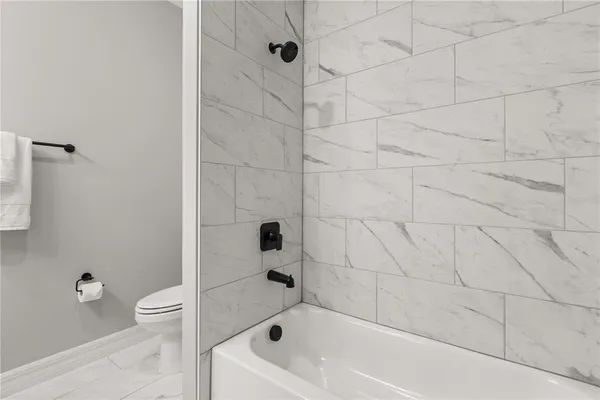 a bathroom with a bathtub and a toilet