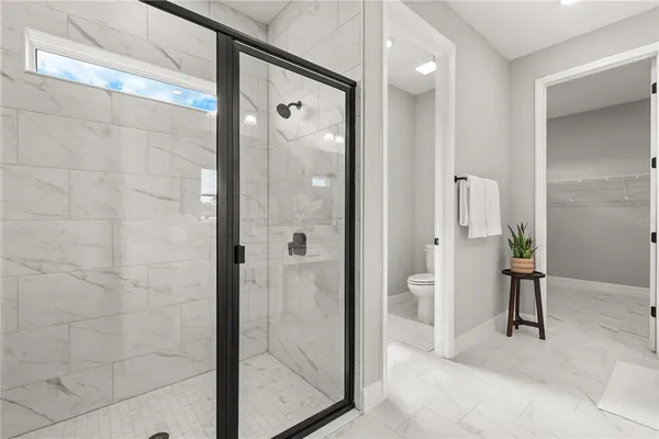 a bathroom with a glass shower door