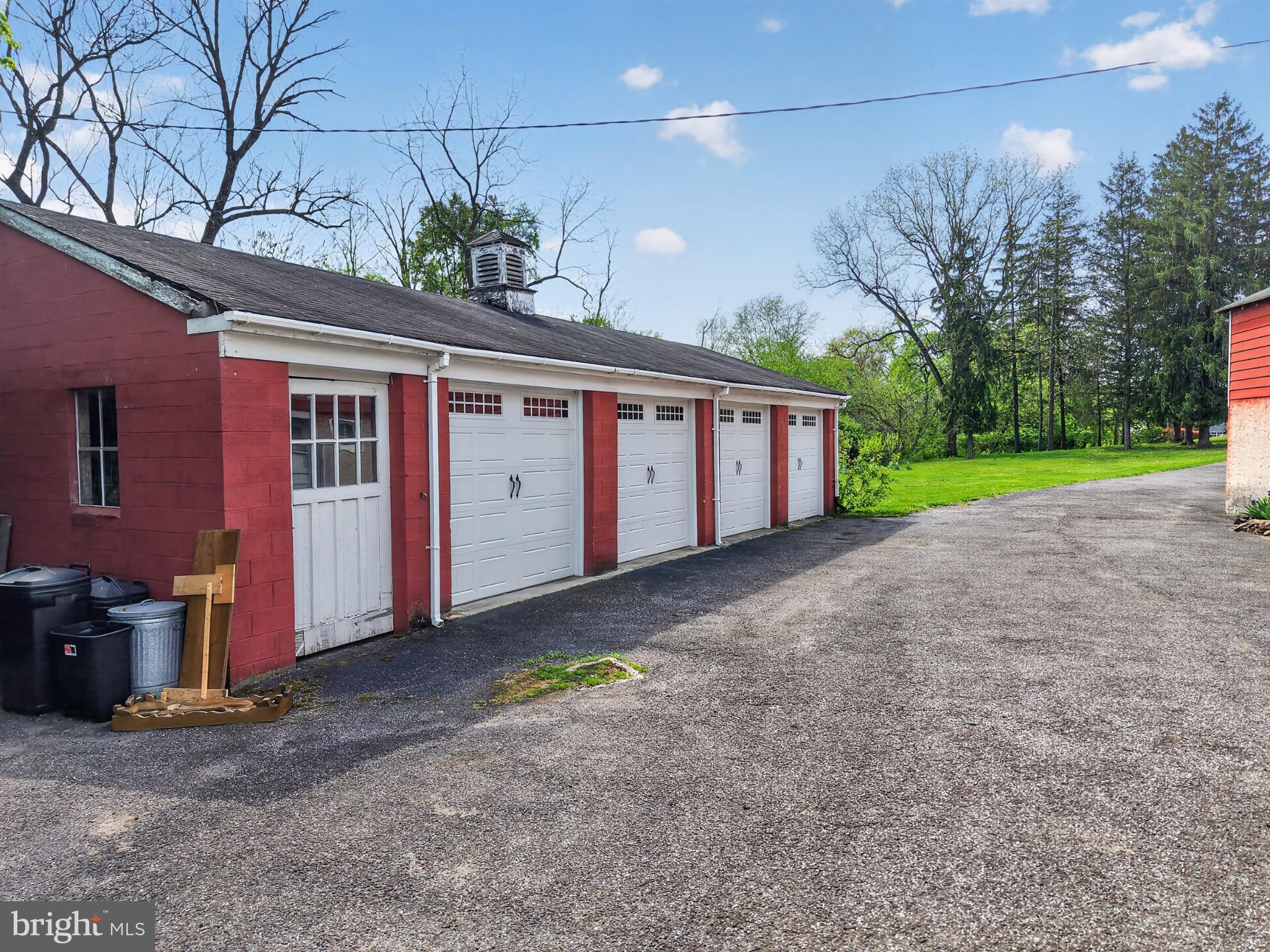 300 Sanatoga Road Pottstown, PA 19465 - Photo 74 of 79 Charming red garage by a lush green lawn.