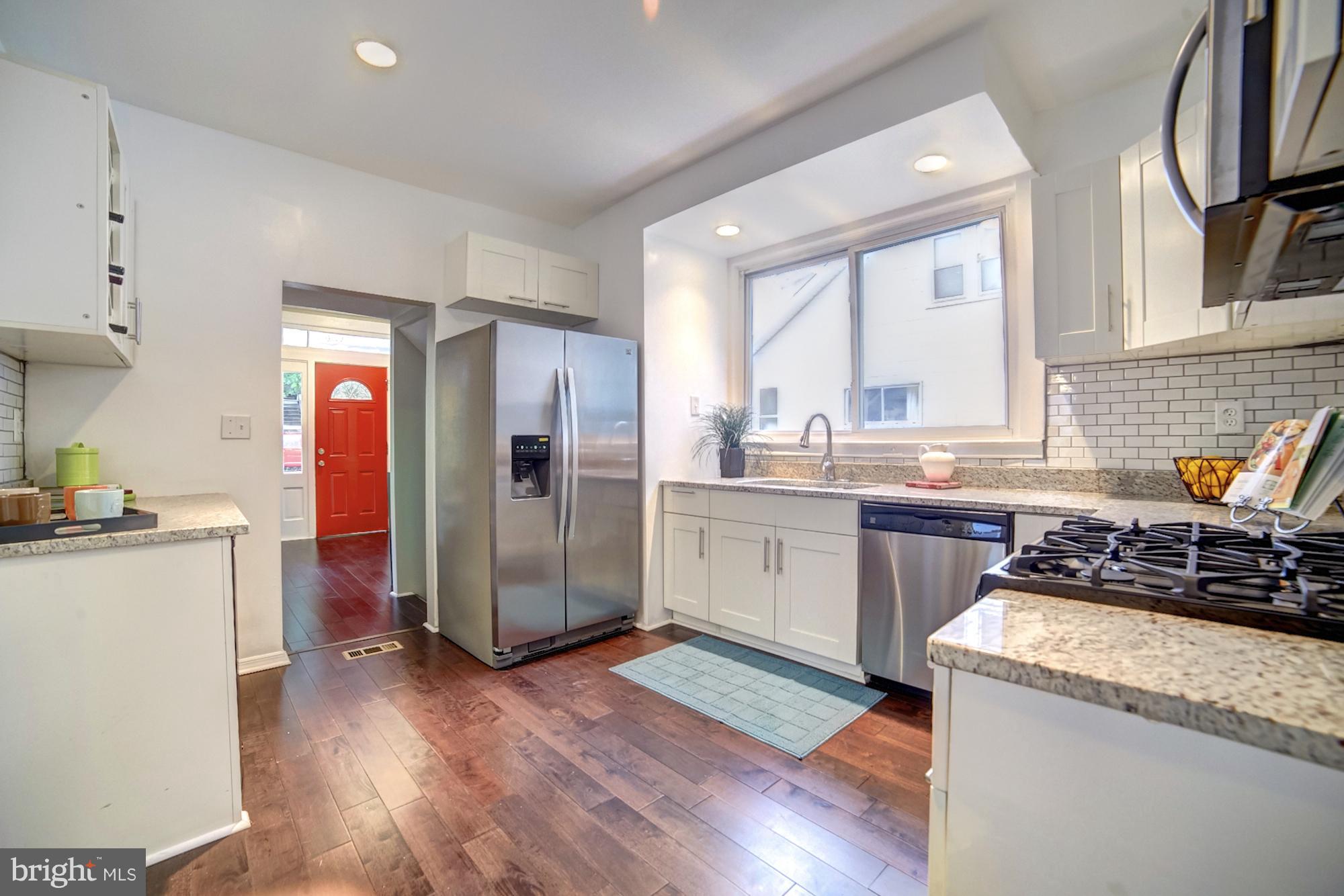 4008 Ridgecroft Road Baltimore, MD 21206 - Photo 6 of 17 a kitchen with a sink stove and refrigerator